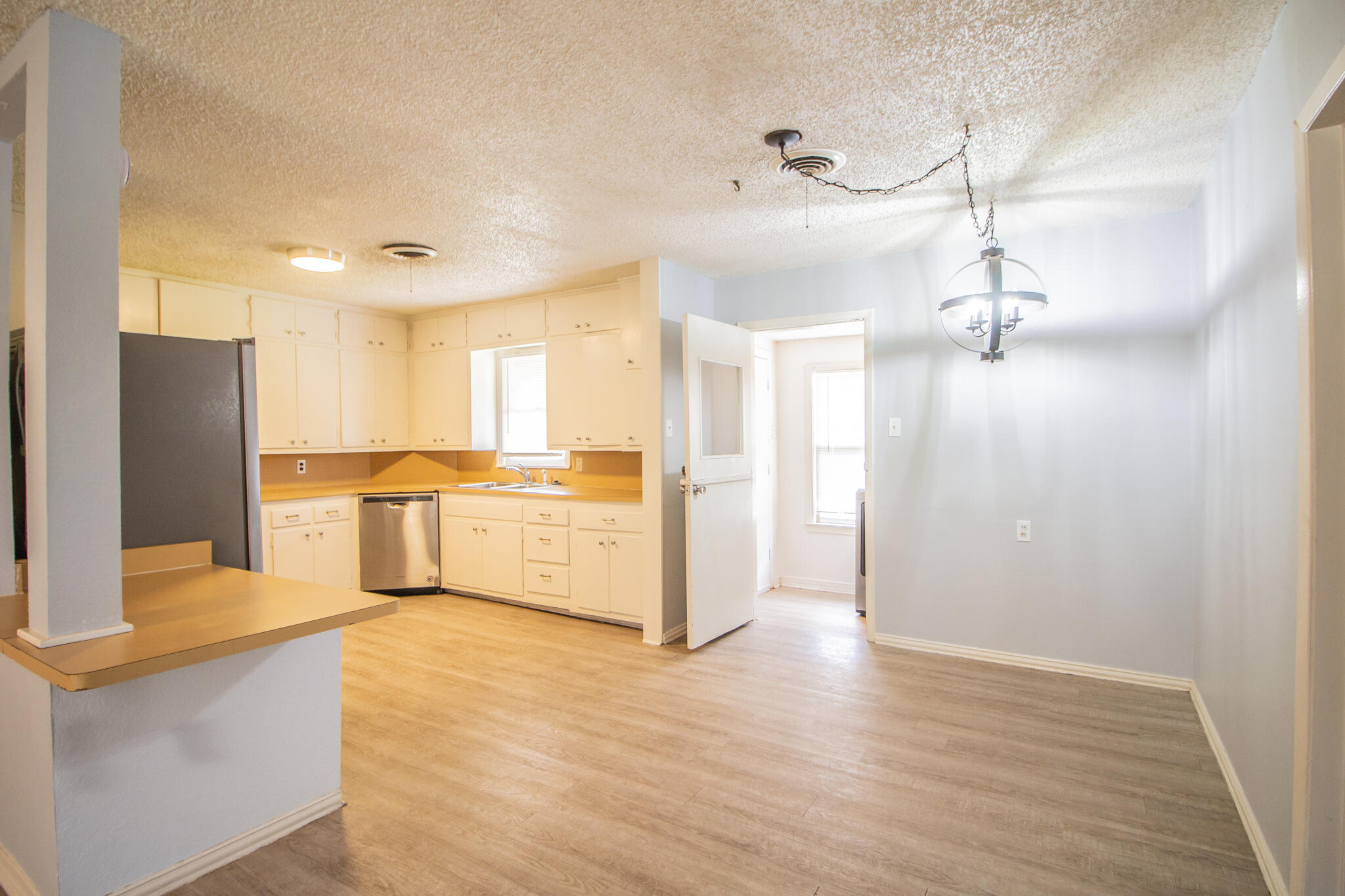 3214 27th Street Lubbock, TX 79410 - Photo 5 of 19 a view of a kitchen with wooden floor
