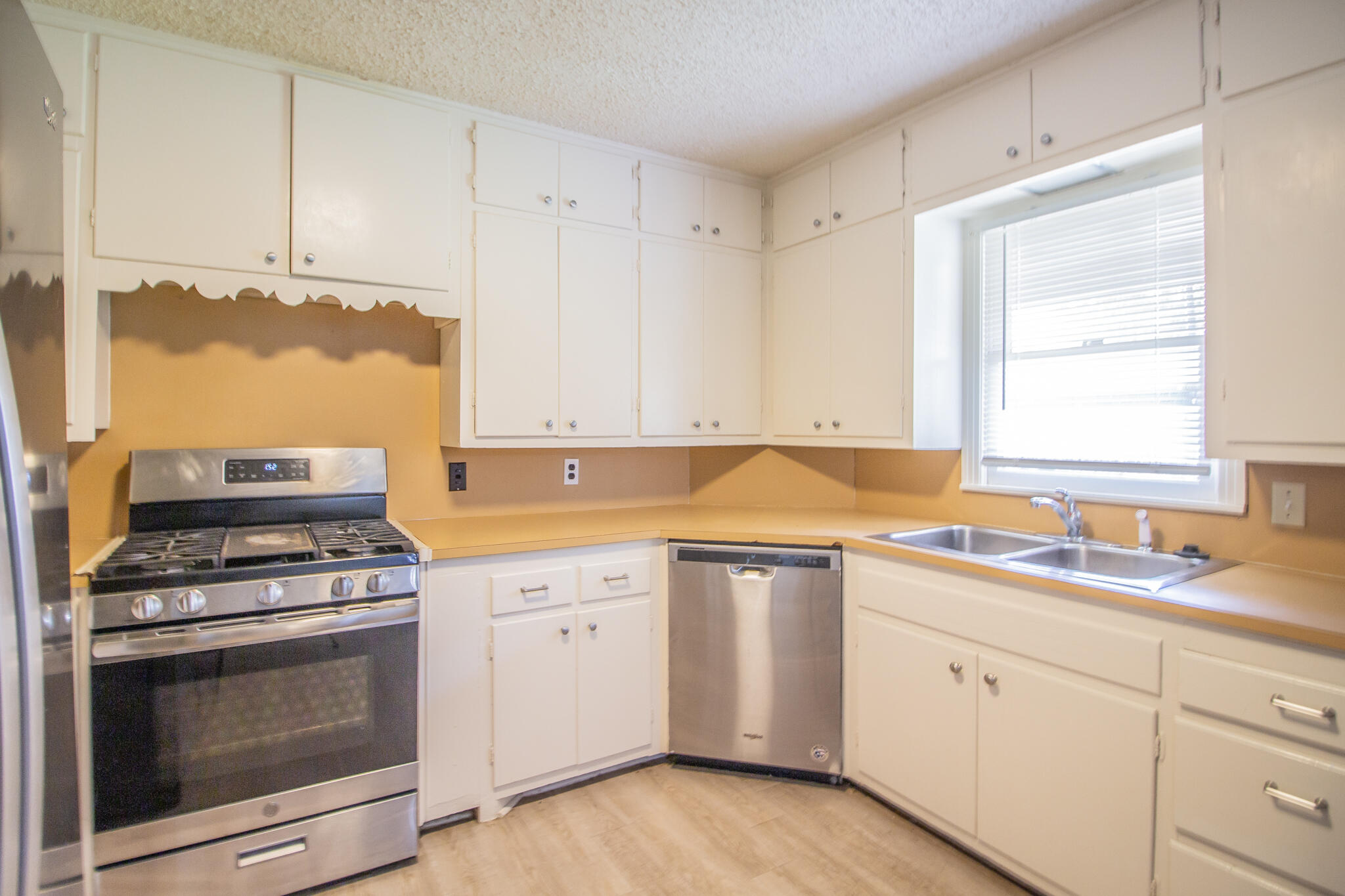 3214 27th Street Lubbock, TX 79410 - Photo 7 of 19 a kitchen with cabinets appliances and a sink
