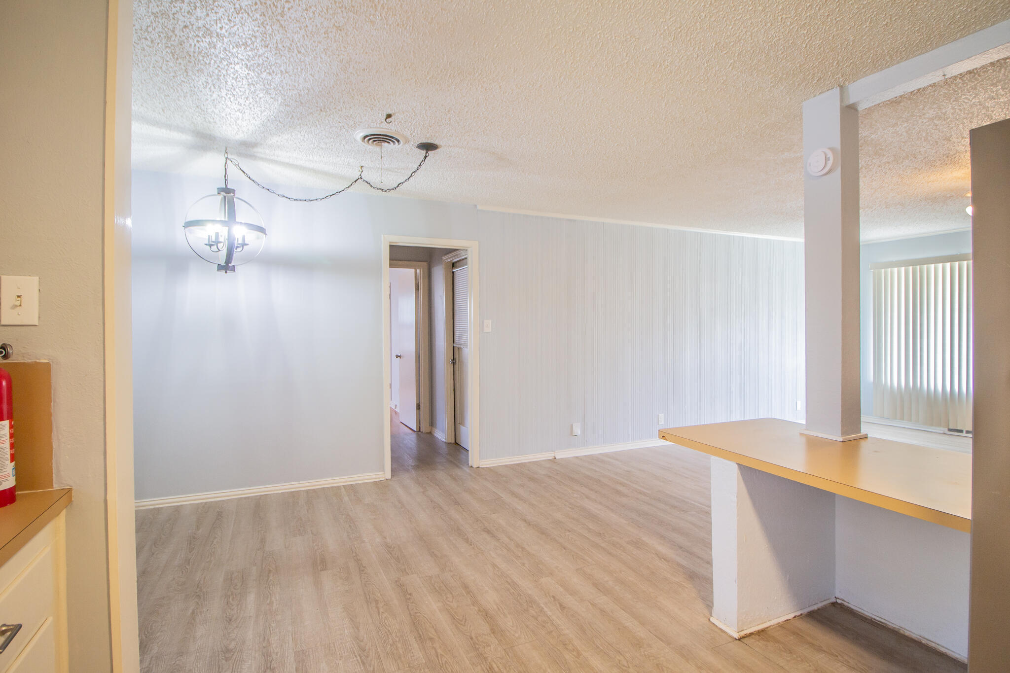 3214 27th Street Lubbock, TX 79410 - Photo 8 of 19 a view of empty room with wooden floor and fan