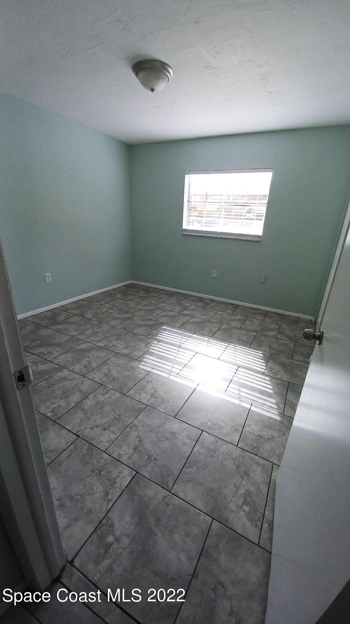 181 Ulster Lane Melbourne, FL 32935 - Photo 13 of 29 a view of an empty room and window