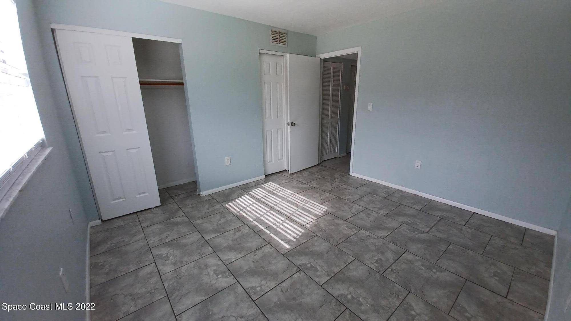 181 Ulster Lane Melbourne, FL 32935 - Photo 14 of 29 a view of room with window and stairs