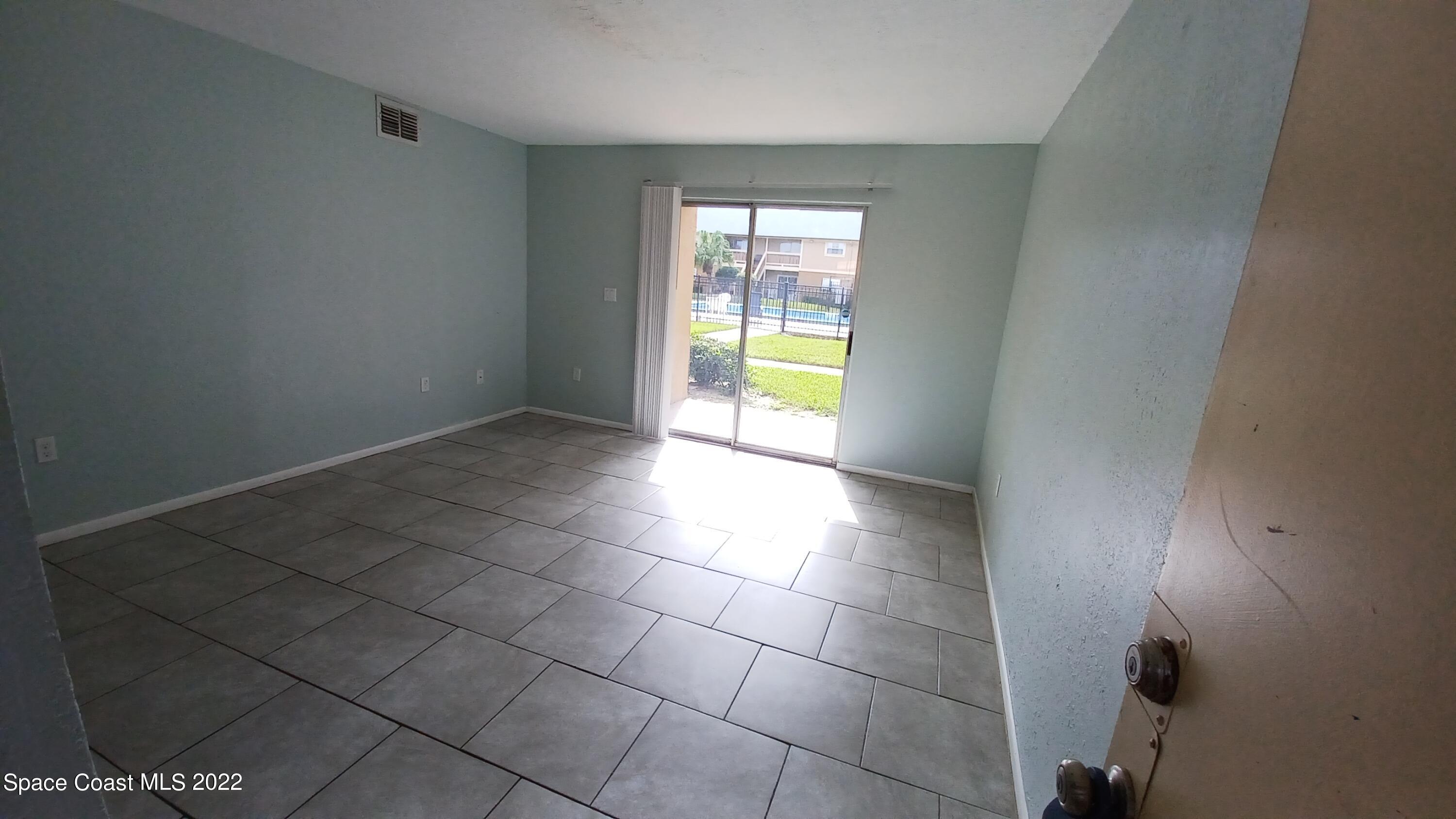 181 Ulster Lane Melbourne, FL 32935 - Photo 2 of 29 a view of an empty room with a window