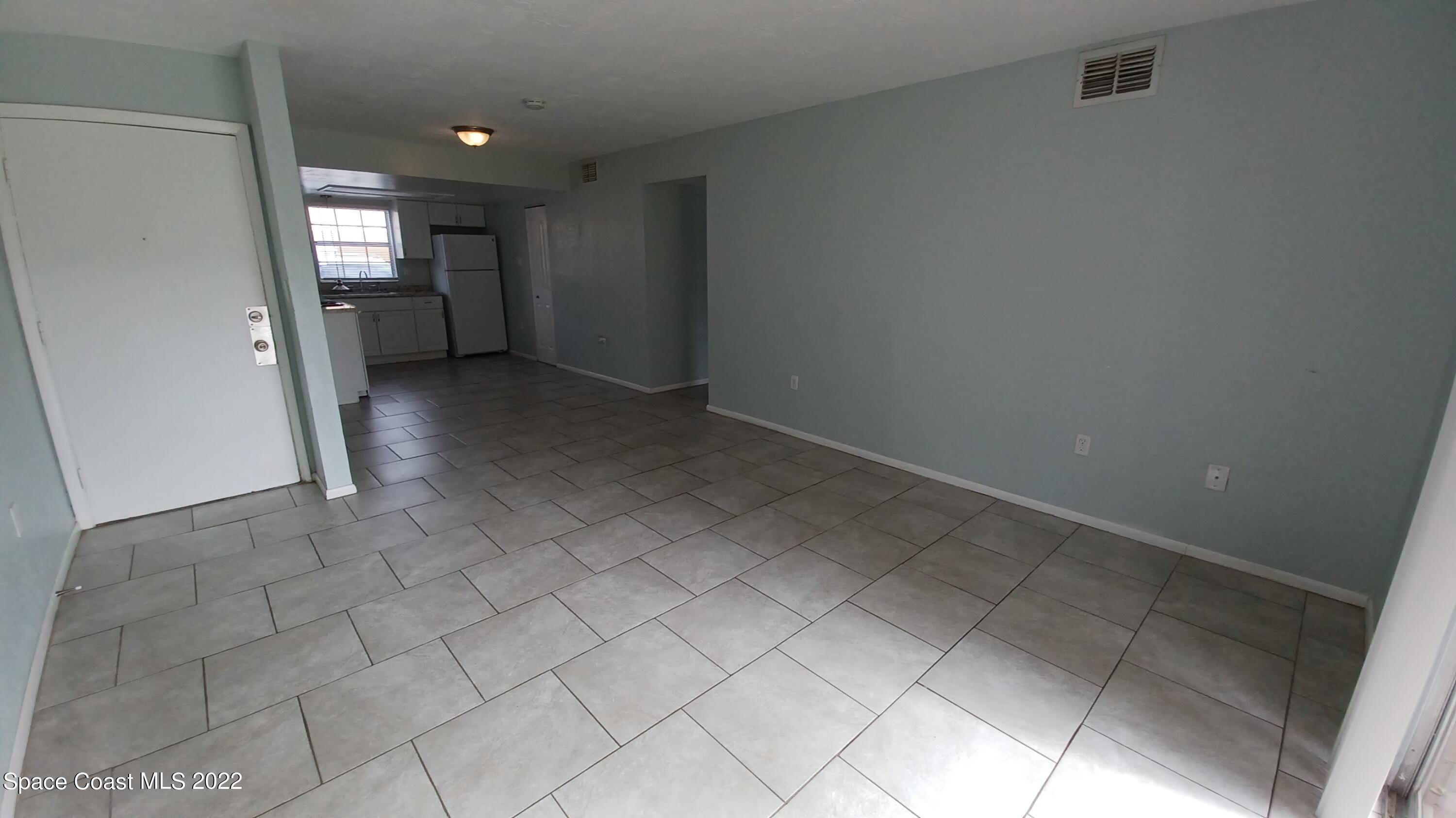 181 Ulster Lane Melbourne, FL 32935 - Photo 5 of 29 a view of an empty room and a window