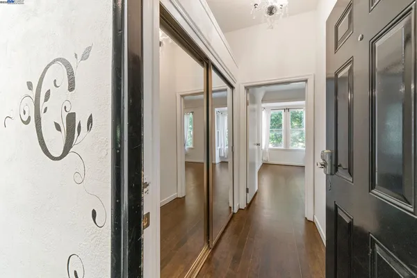 a view of an empty room with wooden floor