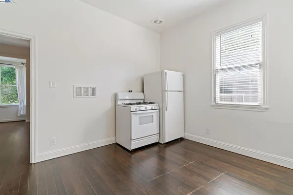 a kitchen with granite countertop white cabinets and a stainless steel appliances