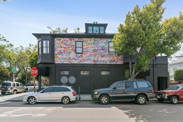 a front view of a building with cars parked