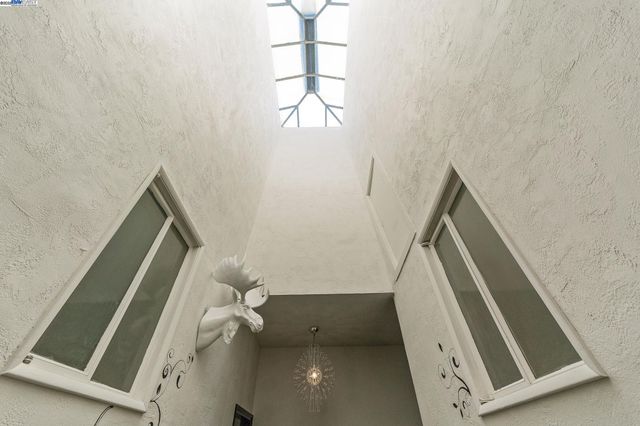 a view of stairs and utility room with windows