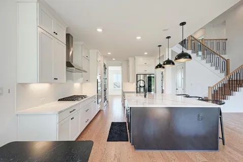 a large kitchen with a table and chairs
