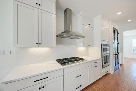 a kitchen with stainless steel appliances kitchen island a chandelier