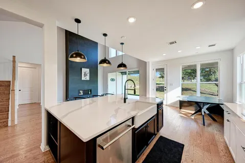 a kitchen with cabinets stainless steel appliances and a counter space
