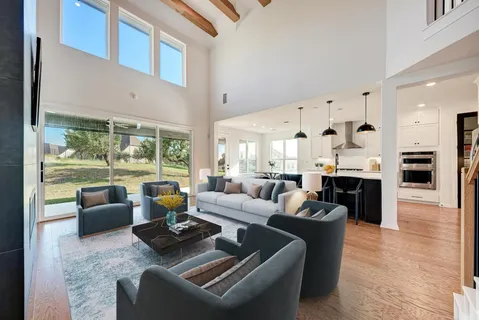 a living room with fireplace furniture and a large window