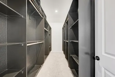 a hall with a sink and a mirror