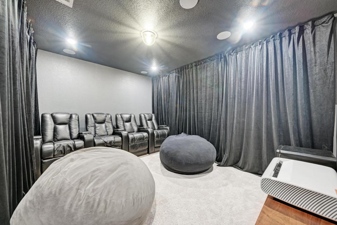 156 Verdejo Drive Dripping Springs, TX 78620 - Photo 26 of 40 a living room with furniture and a chandelier