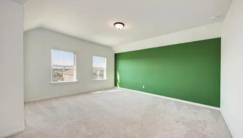 a room with pool table and windows