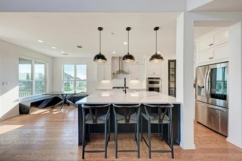 a dinning area with furniture and wooden floor