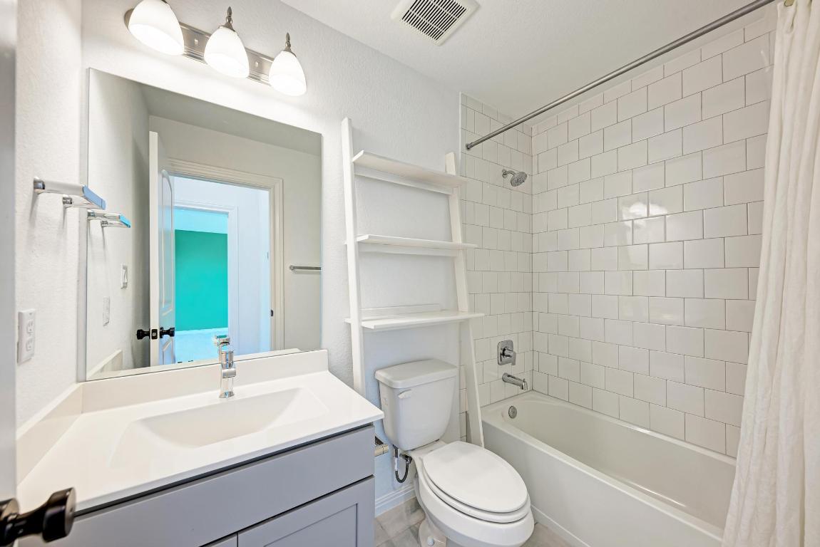 156 Verdejo Drive Dripping Springs, TX 78620 - Photo 28 of 40 a bathroom with a sink a toilet and shower