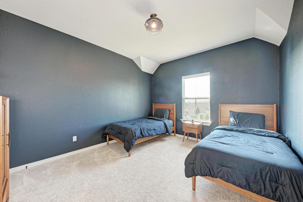156 Verdejo Drive Dripping Springs, TX 78620 - Photo 29 of 40 a bedroom with a bed and a window