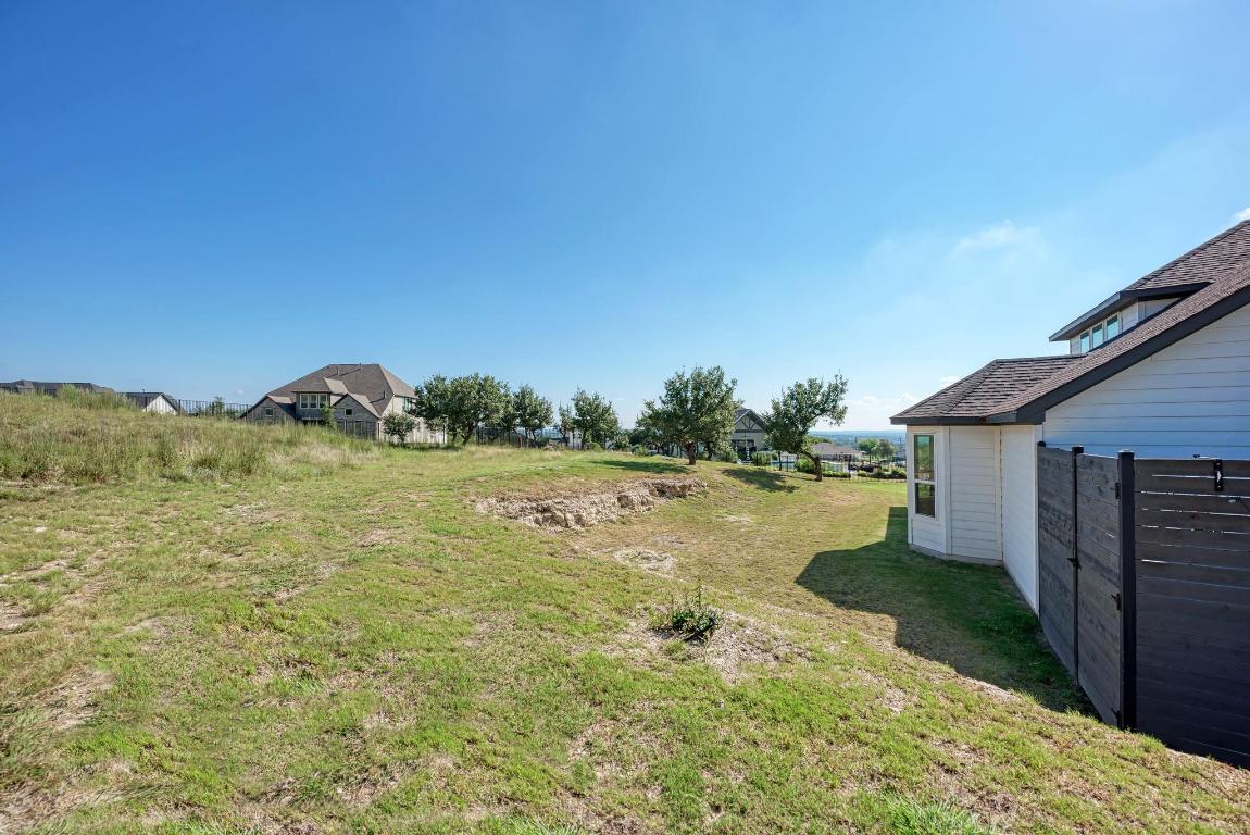 156 Verdejo Drive Dripping Springs, TX 78620 - Photo 37 of 40 a view of a lake with a yard