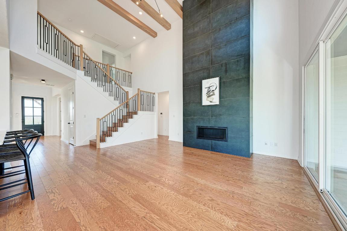 156 Verdejo Drive Dripping Springs, TX 78620 - Photo 8 of 40 a view of a hallway with wooden floor and staircase