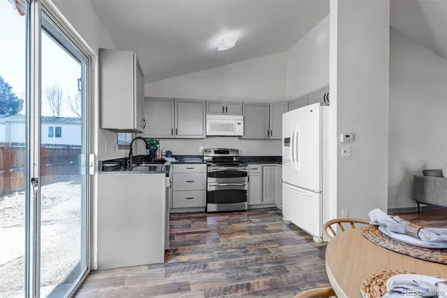 a kitchen with a refrigerator sink and stove