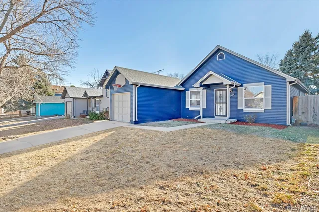 a view of a house with a yard covered in snow