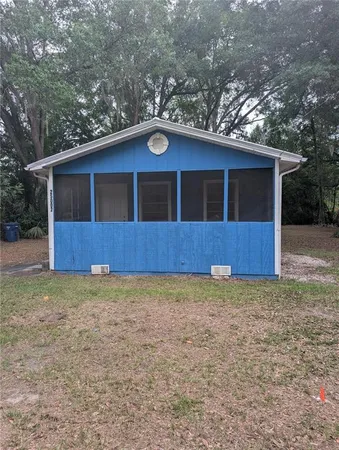 a house with trees in the background