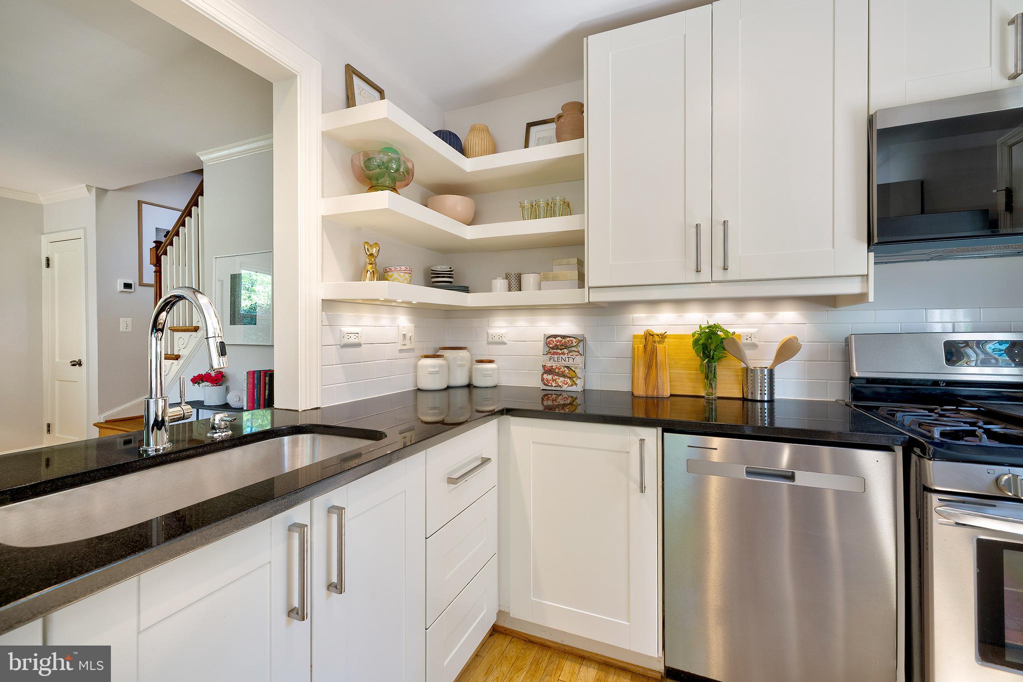 1730 Dublin Drive Silver Spring, MD 20902 - Photo 12 of 50 a kitchen with granite countertop a sink a stove and cabinets