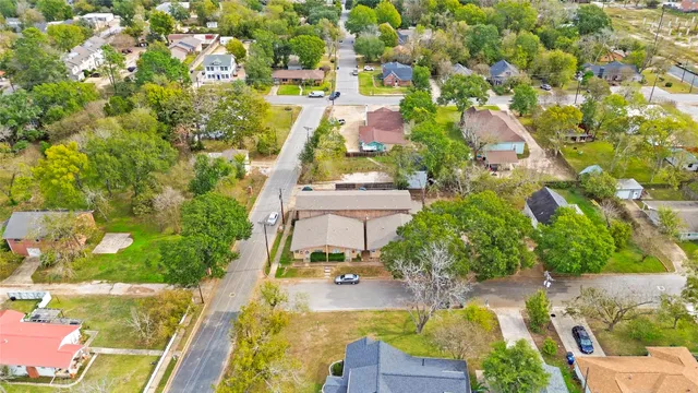 an aerial view of residential houses with outdoor space and street view
