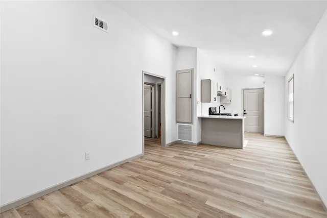 a view of a kitchen with wooden floor