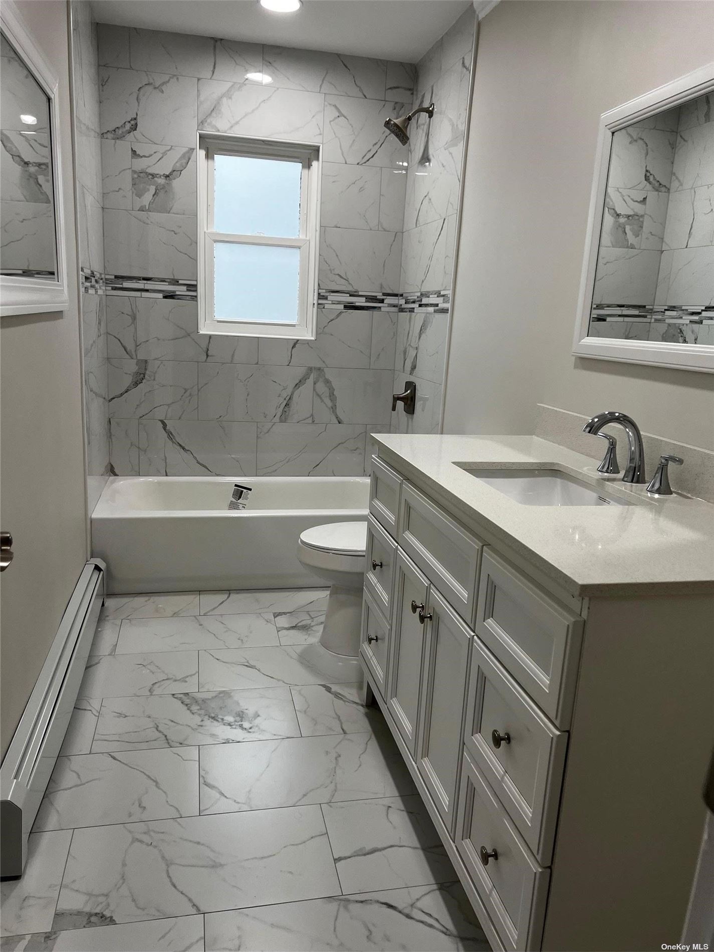 a bathroom with a sink a toilet and bathtub