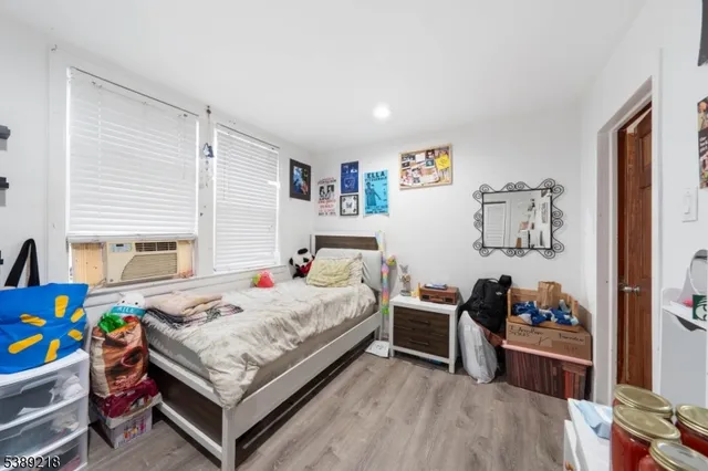 a bedroom with two beds and a window