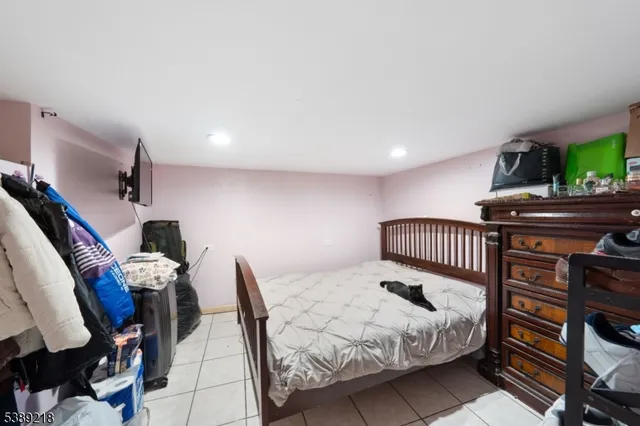 a living room with furniture and a dining table with kitchen view