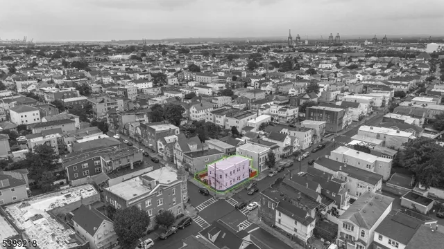 a backyard of a house with table and chairs under an umbrella