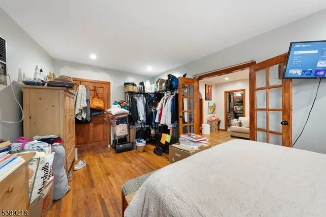 a bedroom with furniture and a flat screen tv