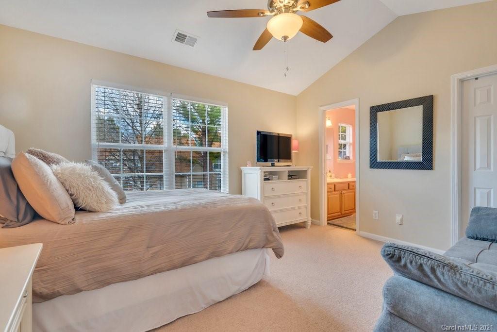 11620 Rabbit Ridge Road Charlotte, NC 28270 - Photo 17 of 24 a bedroom with a bed and a flat screen tv
