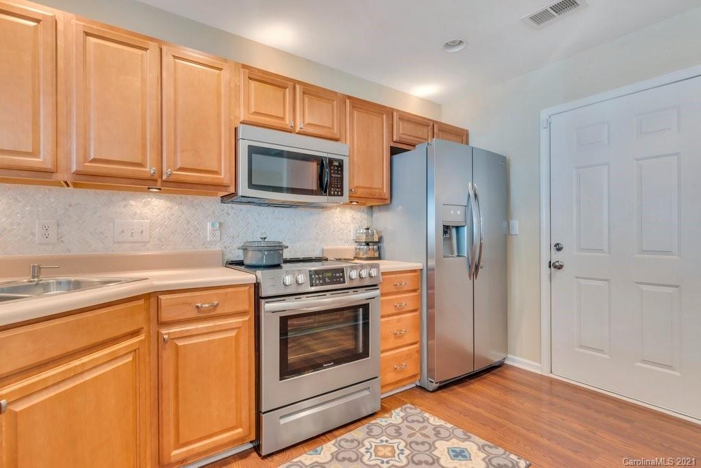 11620 Rabbit Ridge Road Charlotte, NC 28270 - Photo 8 of 24 a kitchen with granite countertop wooden cabinets and stainless steel appliances