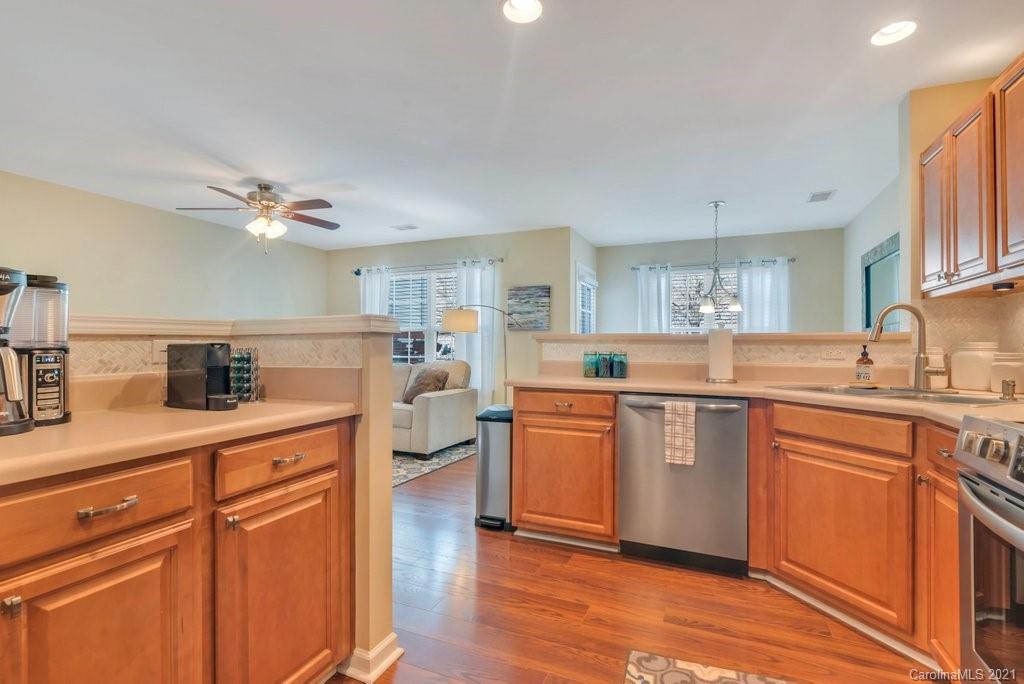11620 Rabbit Ridge Road Charlotte, NC 28270 - Photo 9 of 24 a kitchen with stainless steel appliances a sink cabinets and wooden floor