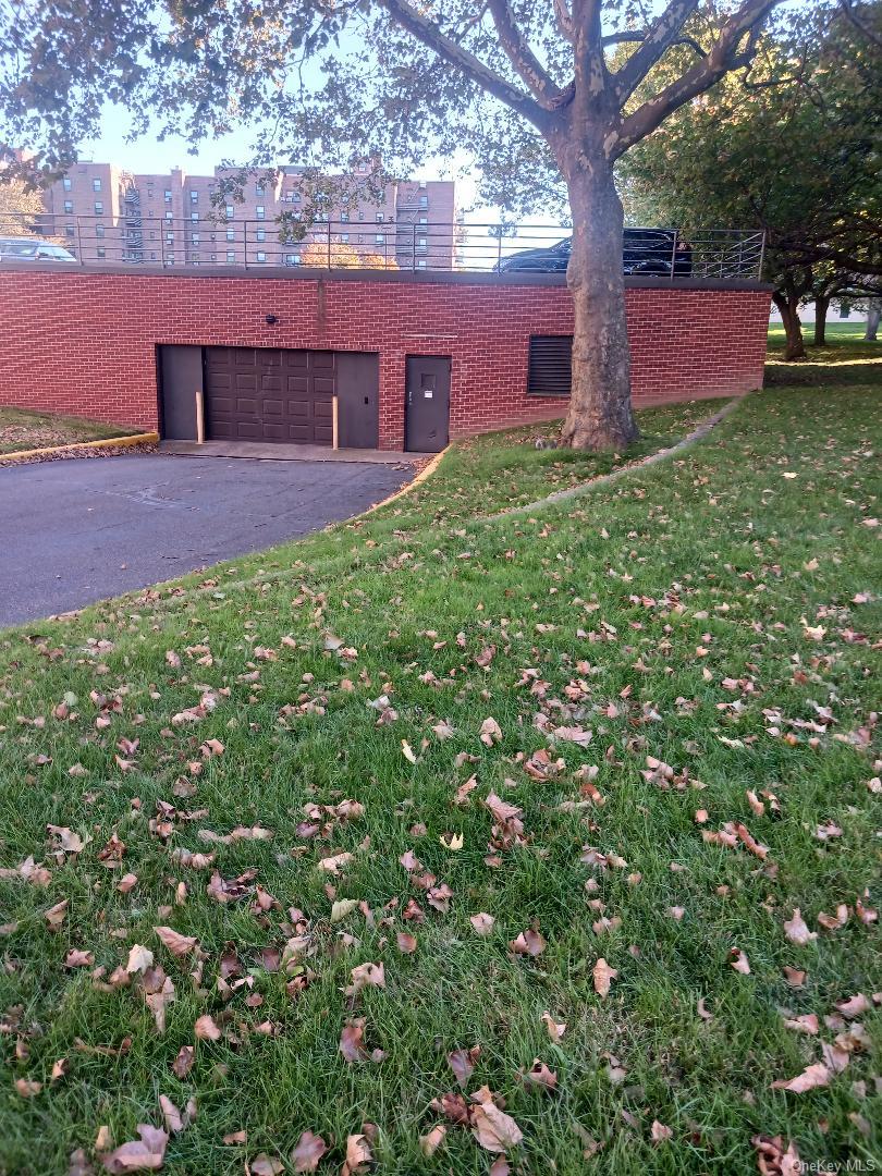 75-24 Bell Boulevard, Unit LD Queens, NY 11364 - Photo 17 of 19 a view of a backyard with a tree