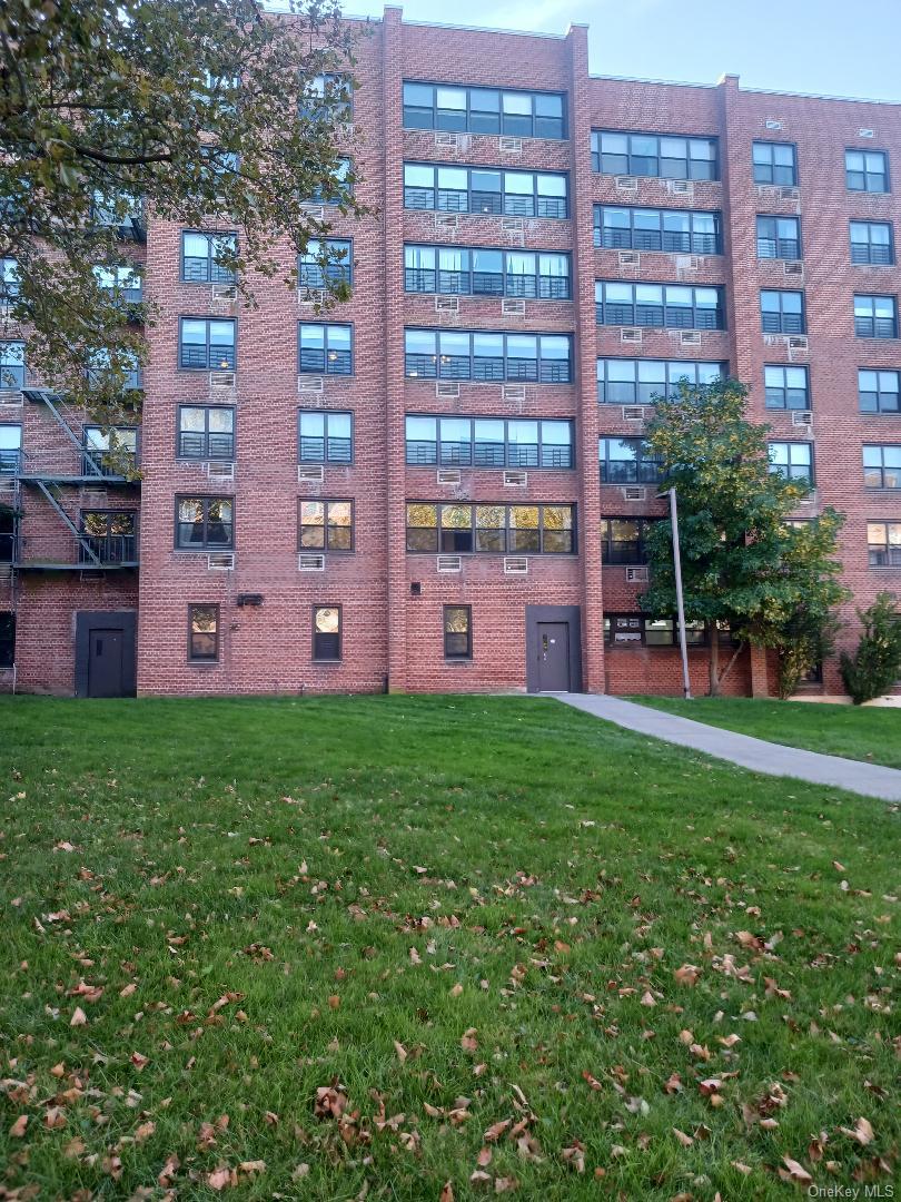 75-24 Bell Boulevard, Unit LD Queens, NY 11364 - Photo 18 of 19 front view of a building with a garden