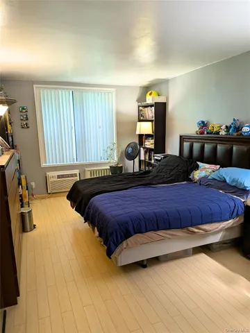 a bedroom with a bed and window