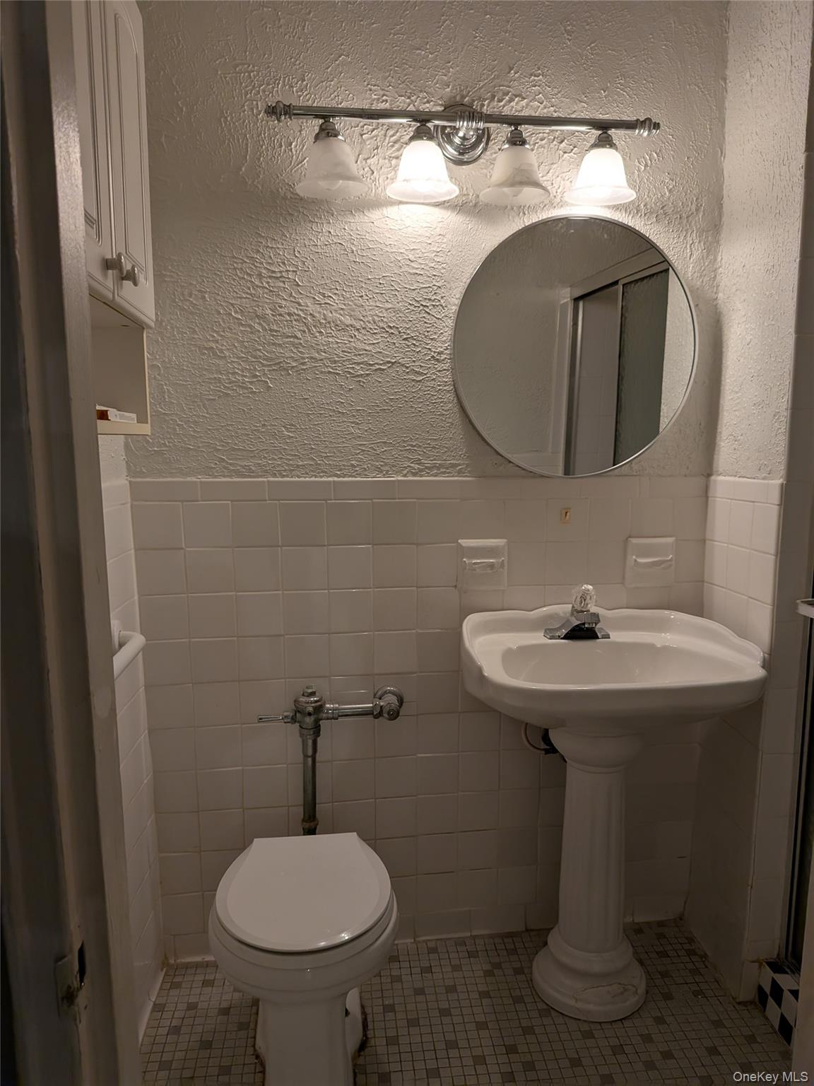 75-24 Bell Boulevard, Unit LD Queens, NY 11364 - Photo 8 of 19 a bathroom with a sink a mirror and toilet