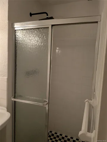 a bathroom with a sink a mirror and toilet