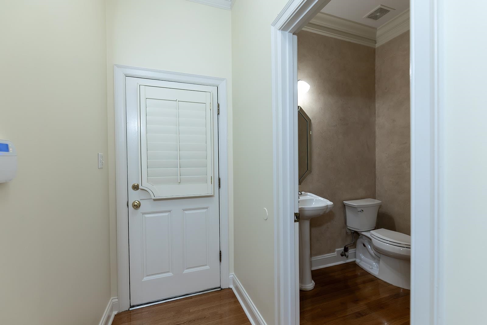 9390 Mayfield Road South Collierville, TN 38017 - Photo 11 of 40 Bathroom with dark wood finished floors and ornamental molding