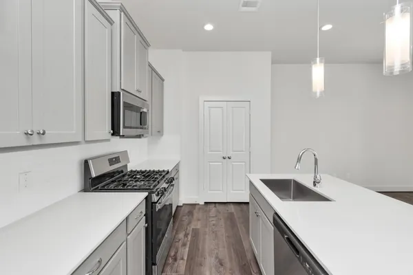 a kitchen that has a sink and a stove