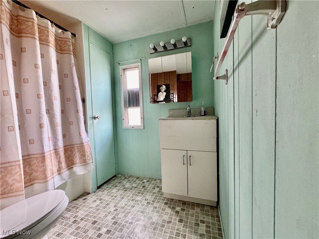 4199 Massillon Road, Unit 11 Uniontown, OH 44685 - Photo 10 of 10 Full bathroom with tile patterned flooring, vanity, toilet, and shower / tub combo