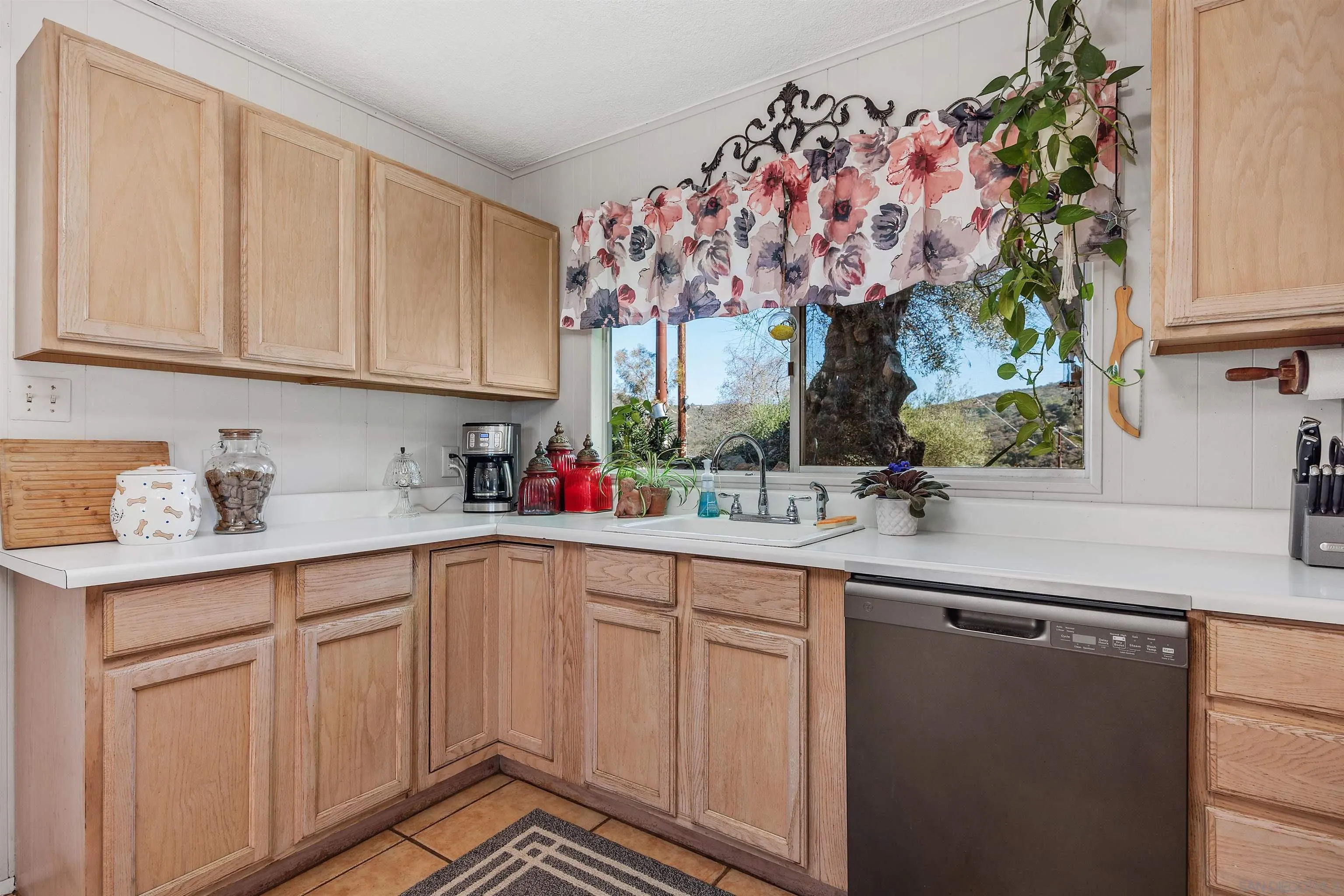 11270 San Luis Rey Drive Valley Center, CA 92082 - Photo 11 of 56 a kitchen with a sink window and cabinets