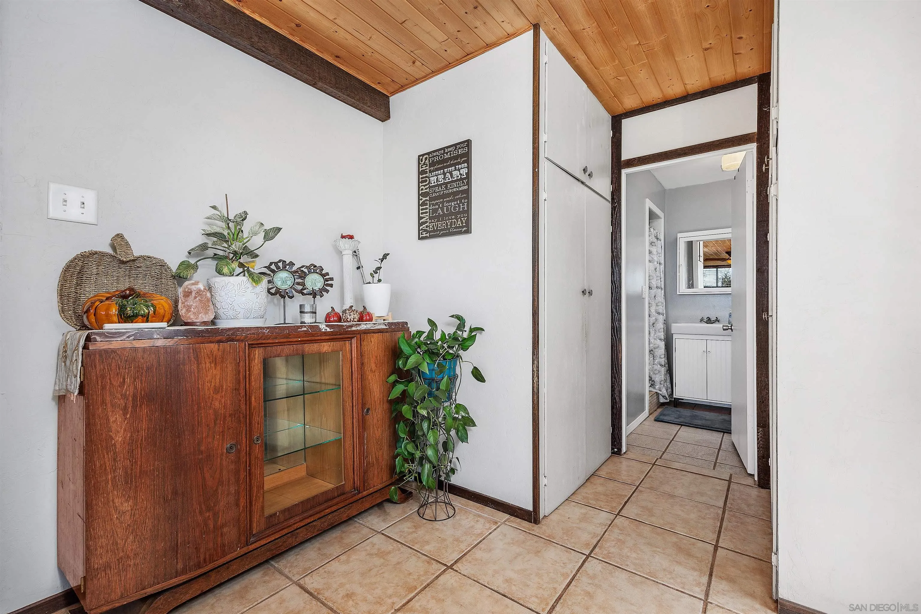 11270 San Luis Rey Drive Valley Center, CA 92082 - Photo 19 of 56 a view of a hallway with wooden floor and a potted plant