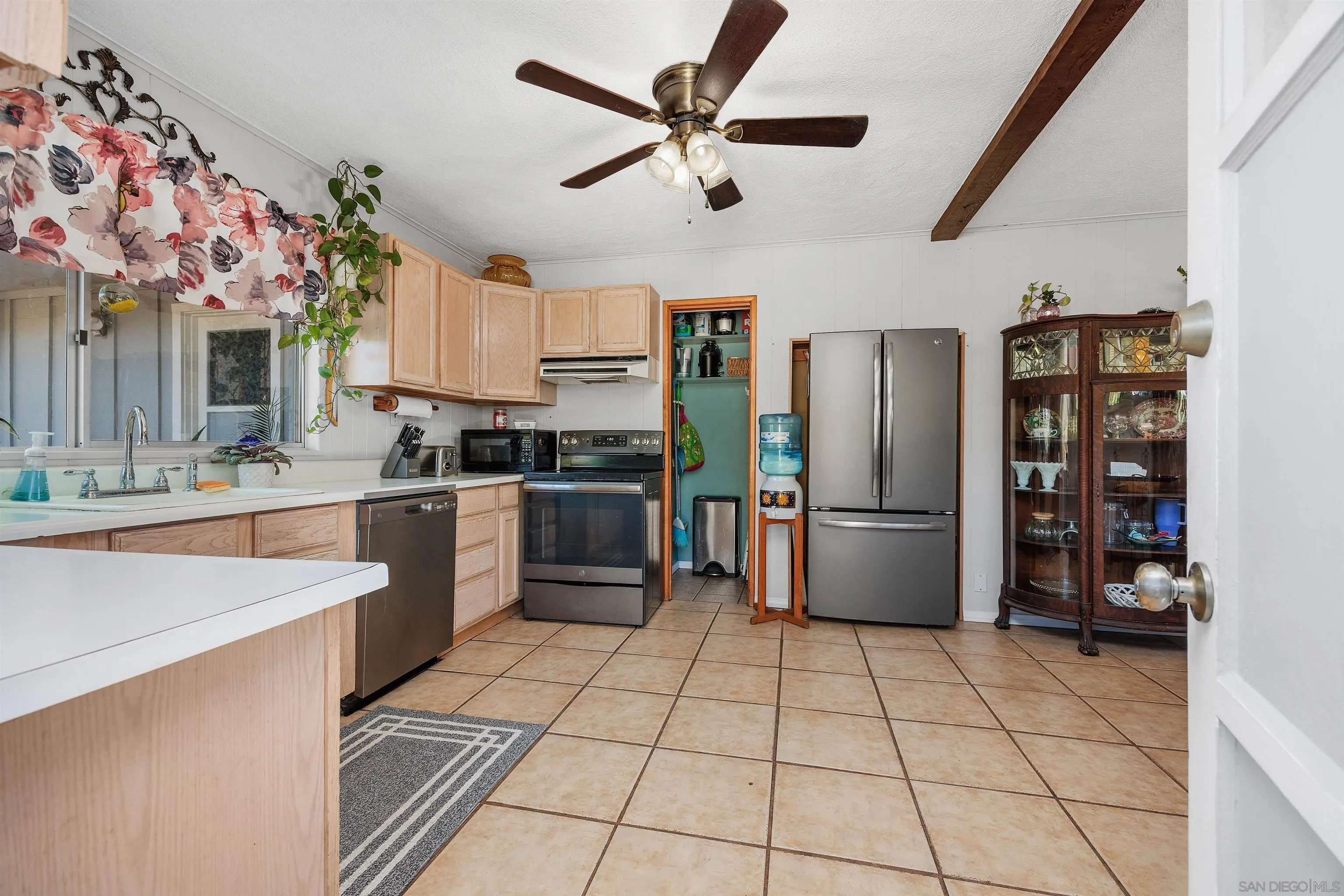11270 San Luis Rey Drive Valley Center, CA 92082 - Photo 9 of 56 a kitchen with stainless steel appliances a sink a stove a refrigerator and cabinets