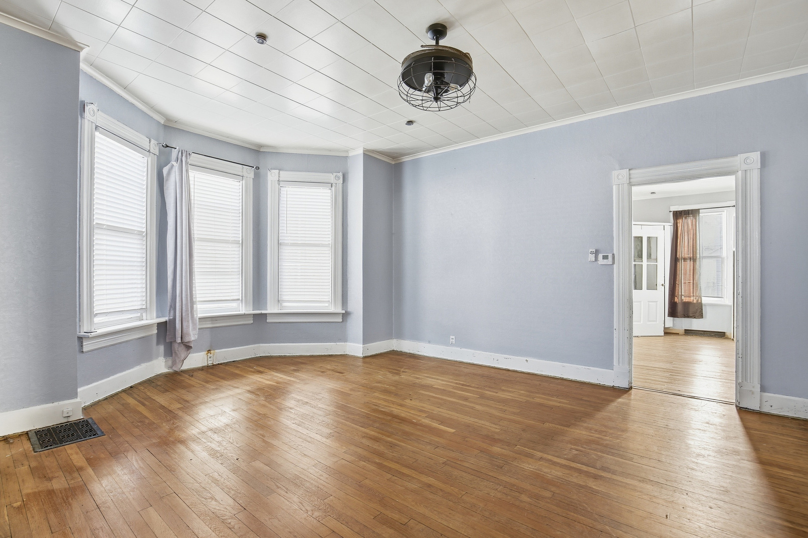 2115 West 4th Street Davenport, IA 52802 - Photo 14 of 24 an empty room with wooden floor and windows