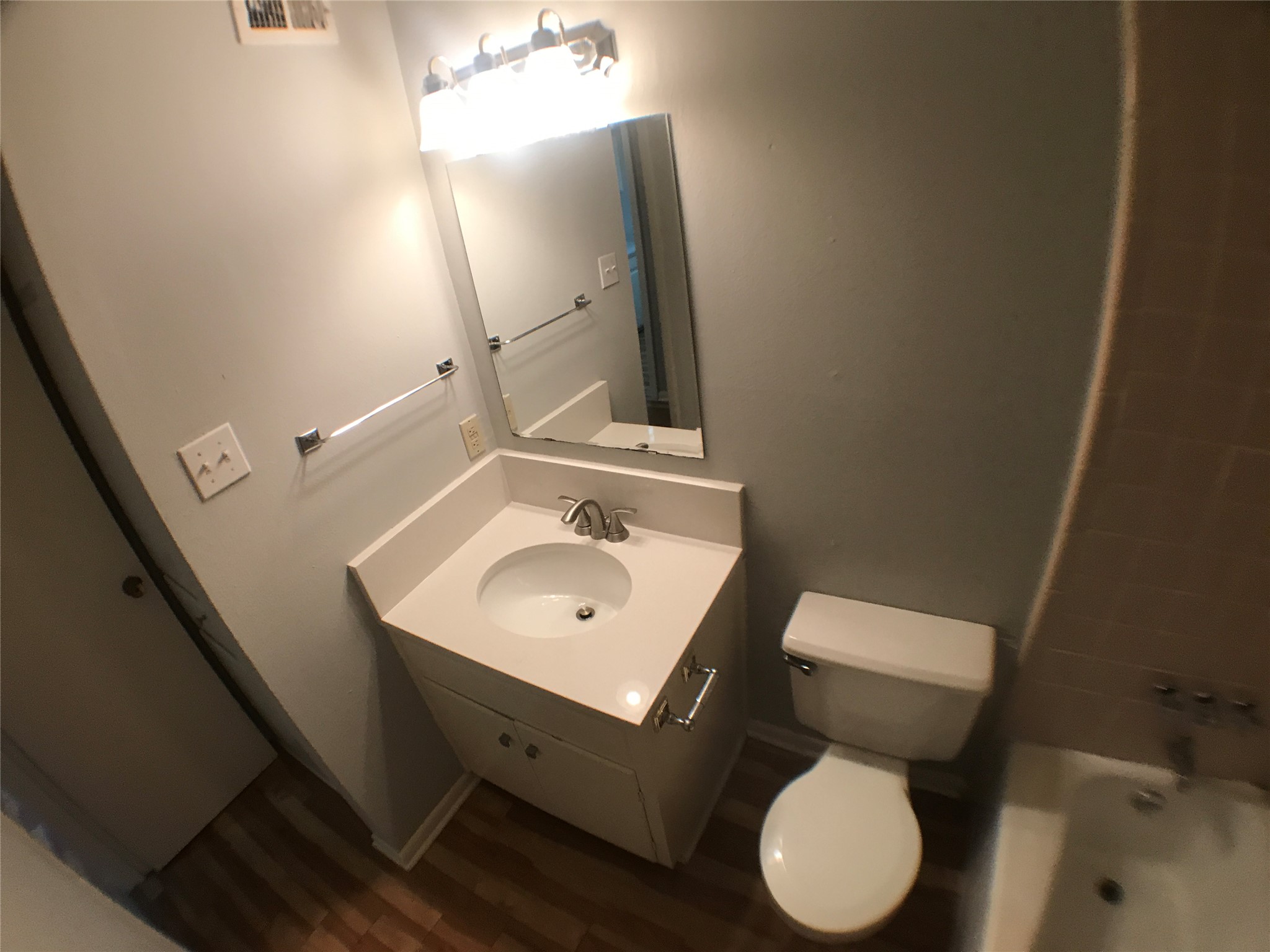 5001 Bull Creek Road, Unit 111 Austin, TX 78731 - Photo 7 of 11 A well-appointed bathroom features a single vanity, a toilet, and a bathtub with tiled walls.